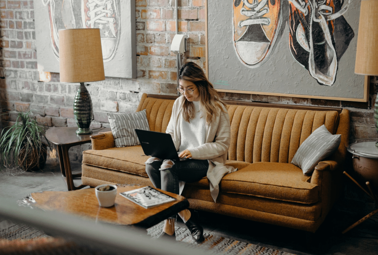 Young woman using computer in a couch