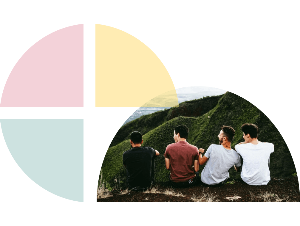 Four guys sits on a hillside overlooking green hills