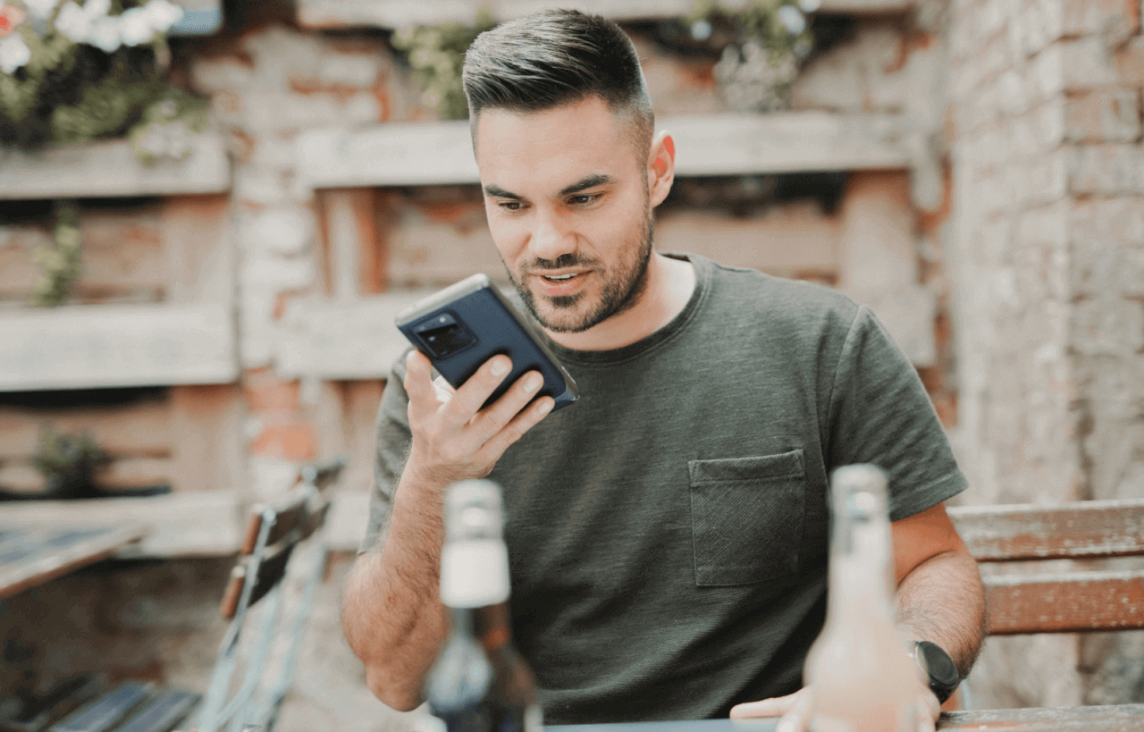 Man using video call while sitting outside a bar