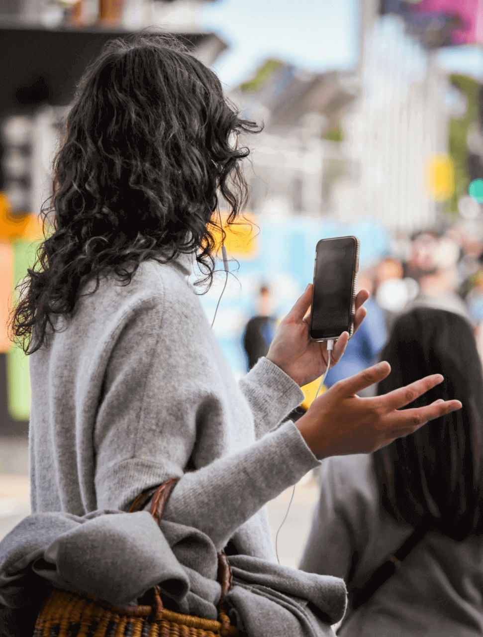 Woman using video call function while walking on the street