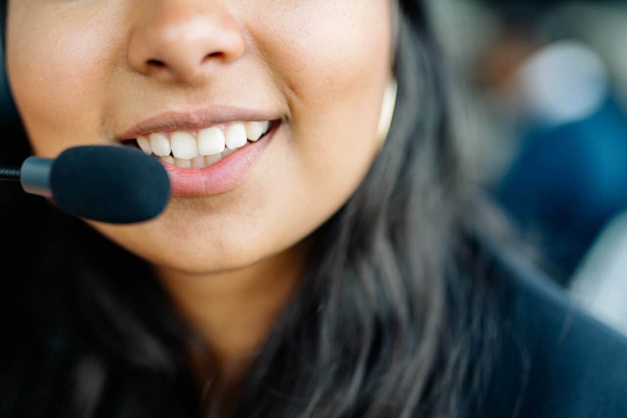 Contact center agent smiling because of first contact resolution